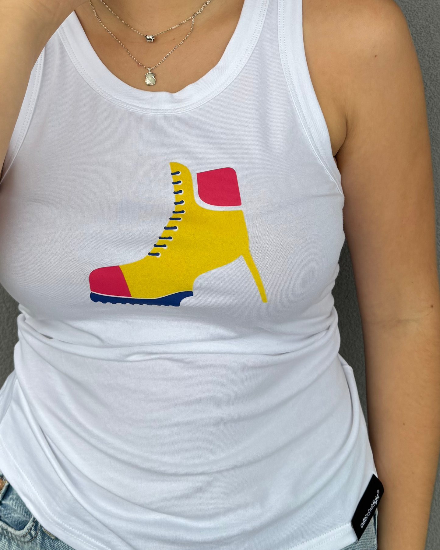 Power In Every Step: White Tank Top With Yellow Boot